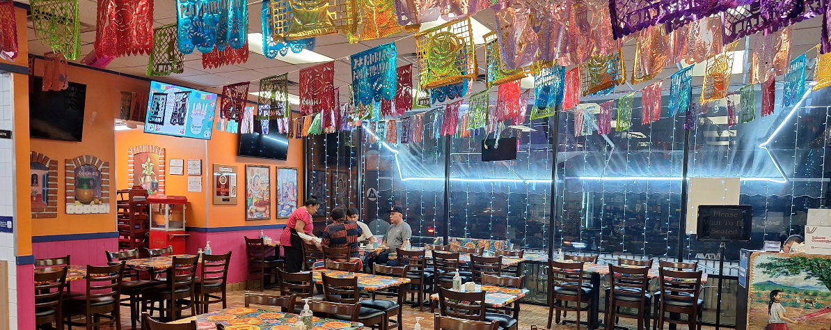 Inside Sabores Oaxaqueños — papel picado and a full dining room